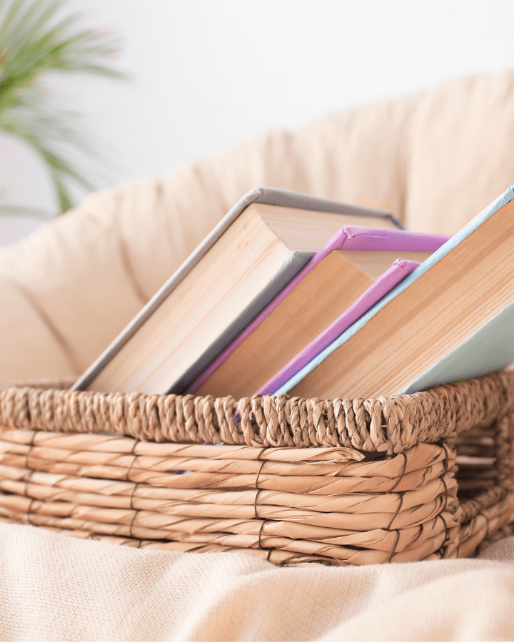 books in a basket sitting in a chair